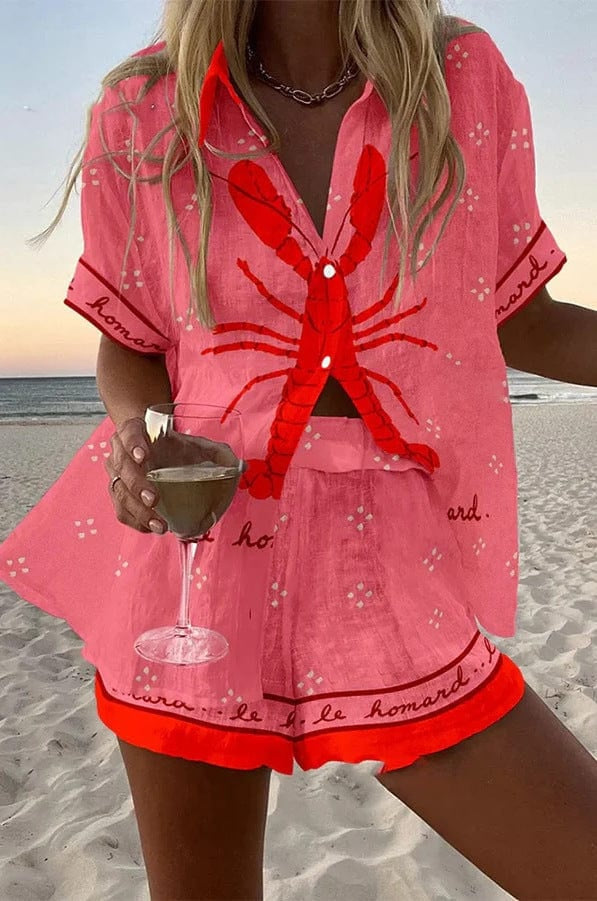 Margaux Matching Set — hero, pink lobster print shirt and shorts on the beach
